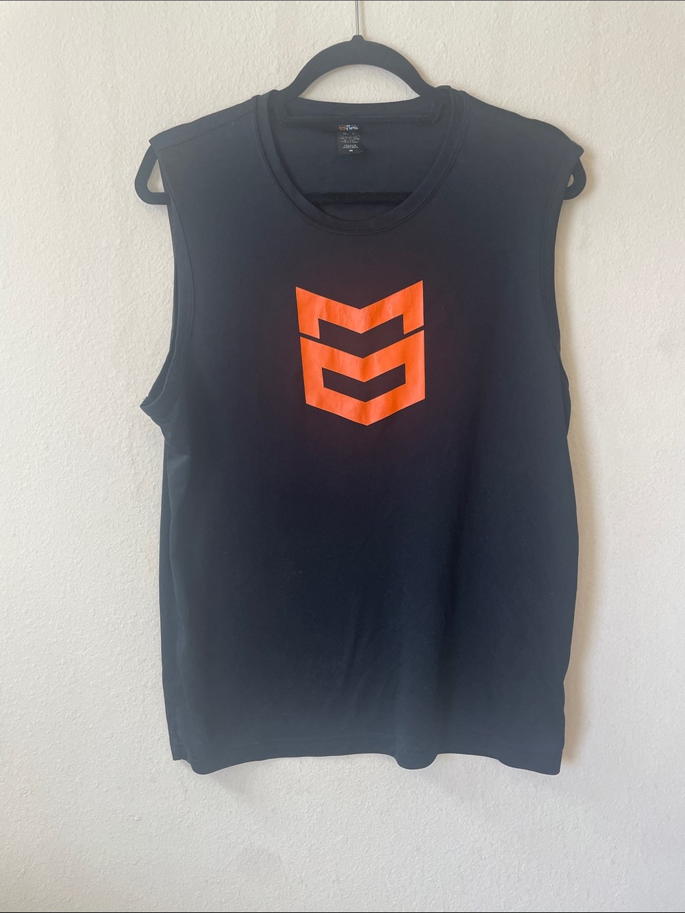 Black Sleeveless Muscle Tee with Orange Chevron Logo